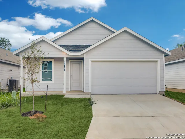 a view of a house with backyard and garden