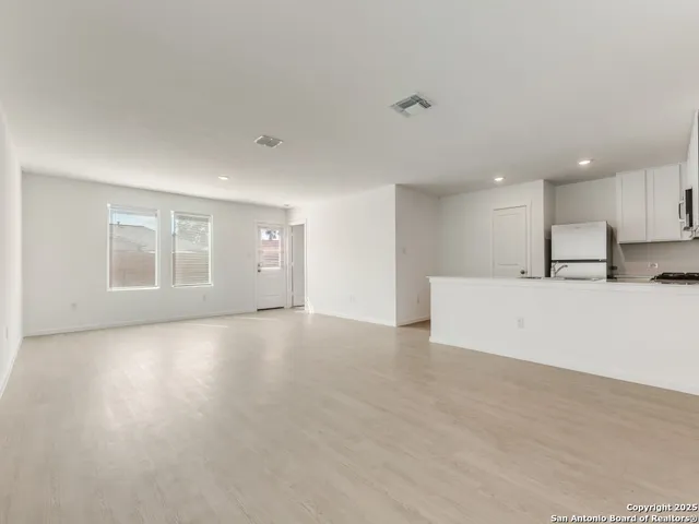 a view of a kitchen with a sink and a window