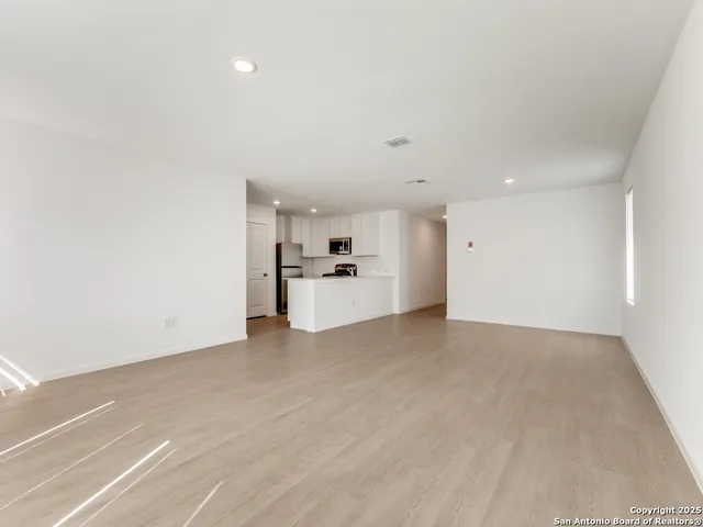 a view of a kitchen with a sink and cabinets
