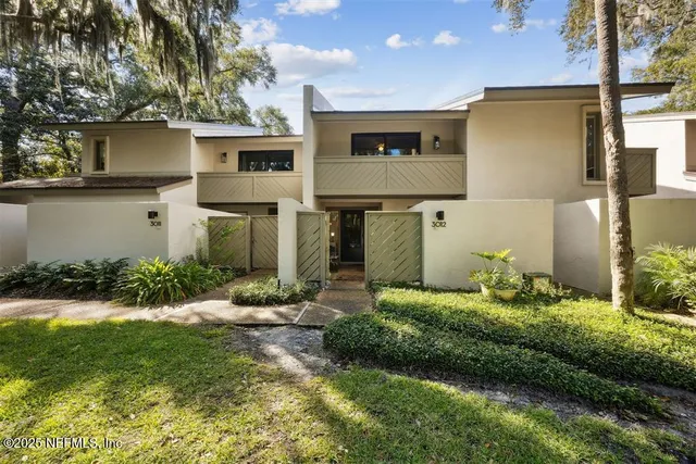 a front view of a house with a yard and a garage