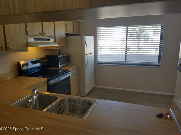 a kitchen with a sink and a refrigerator