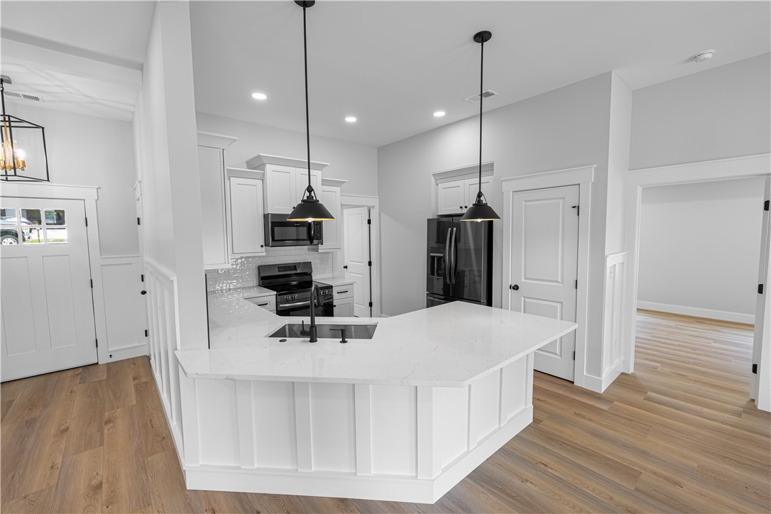 105 Leon Drive Anderson, SC 29621 - Photo 11 of 46 This modern kitchen features a spacious island, sleek appliances, and ample cabinet space.