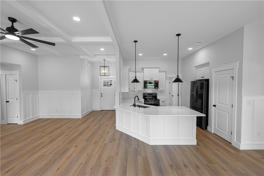 105 Leon Drive Anderson, SC 29621 - Photo 12 of 46 This bright, open concept living space features a functional kitchen island and warm flooring.