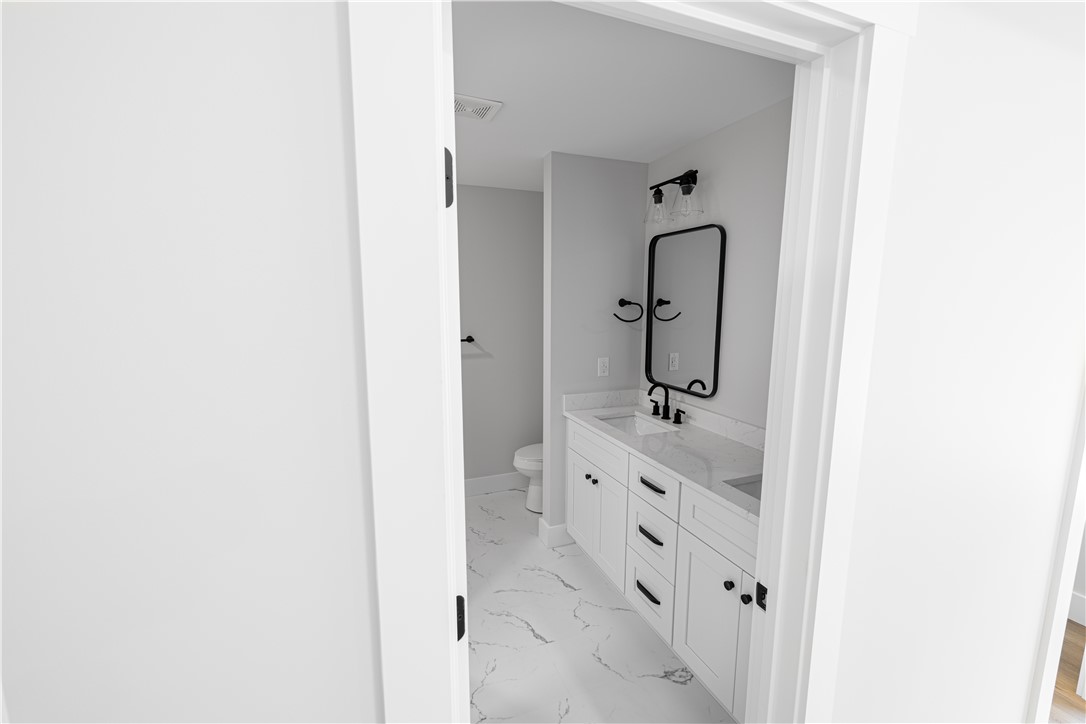 105 Leon Drive Anderson, SC 29621 - Photo 17 of 46 This bathroom features a contemporary design with dual vanities, offering both style and functionality.