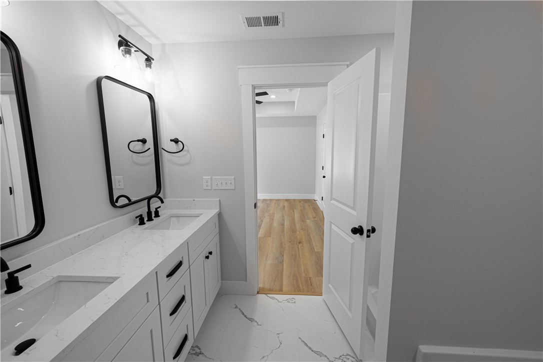 105 Leon Drive Anderson, SC 29621 - Photo 18 of 46 This sleek bathroom features double vanities, offering both style and functionality.