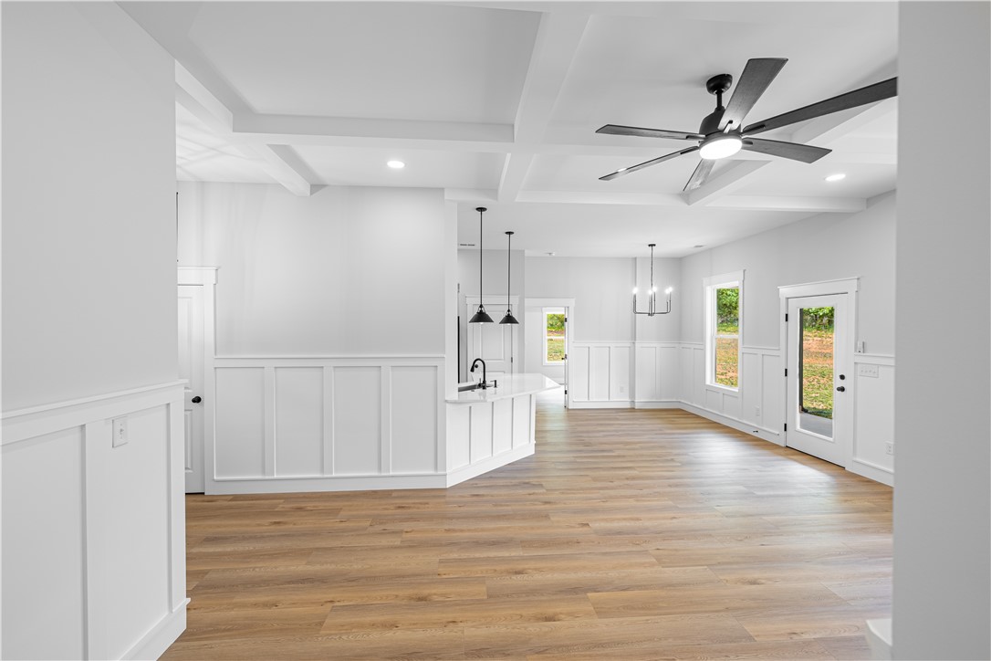 105 Leon Drive Anderson, SC 29621 - Photo 19 of 46 This bright, open concept living space features a kitchen island and natural wood flooring.