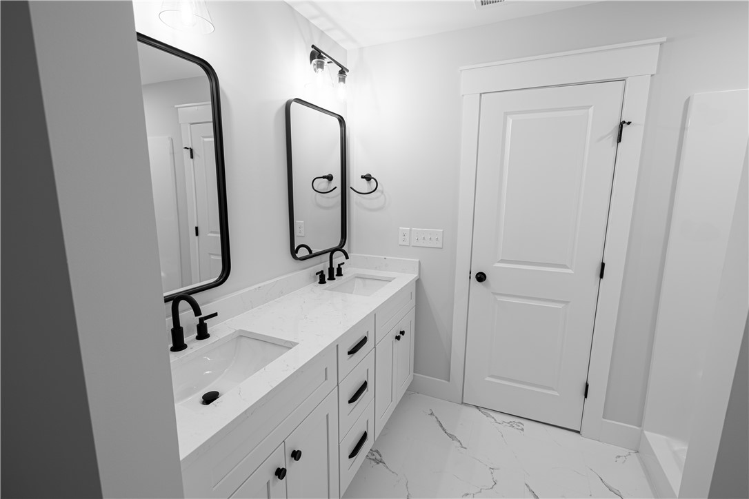 105 Leon Drive Anderson, SC 29621 - Photo 20 of 46 This modern bathroom features a double vanity and sleek fixtures.