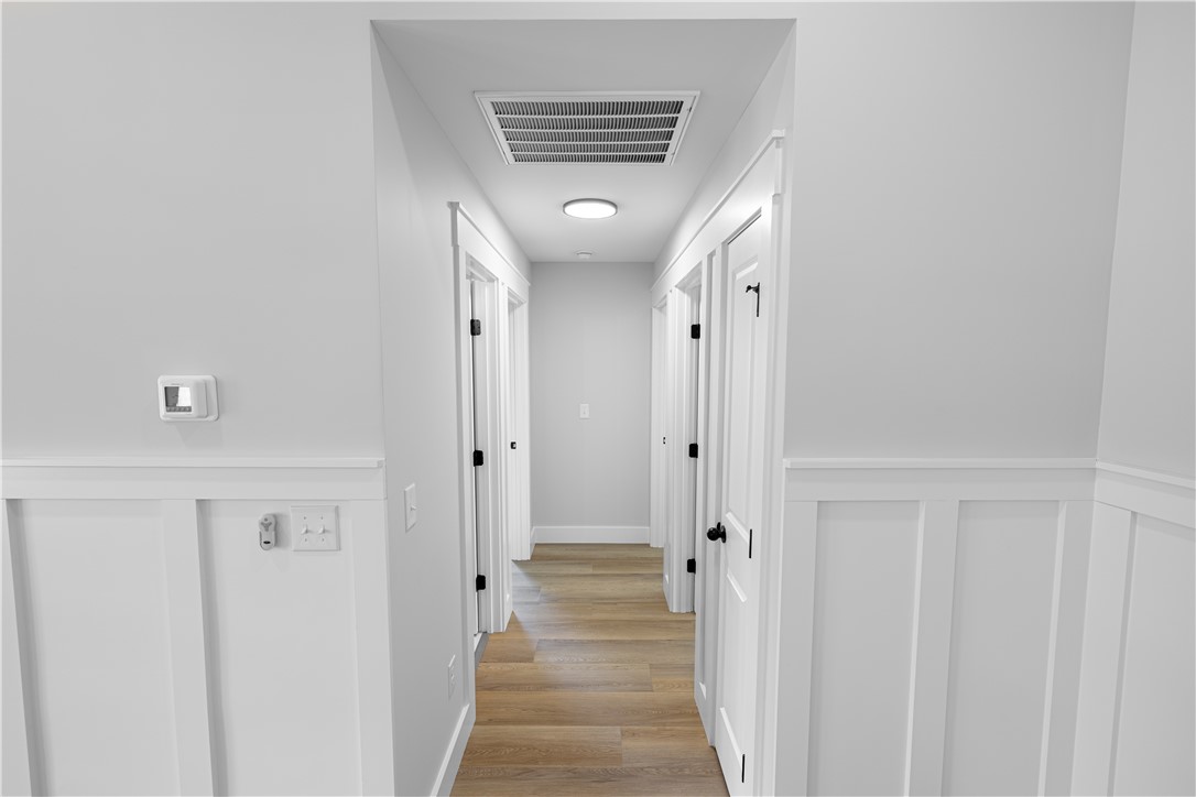 105 Leon Drive Anderson, SC 29621 - Photo 24 of 46 This sleek hallway features contemporary board and batten detailing, creating a clean, modern aesthetic.