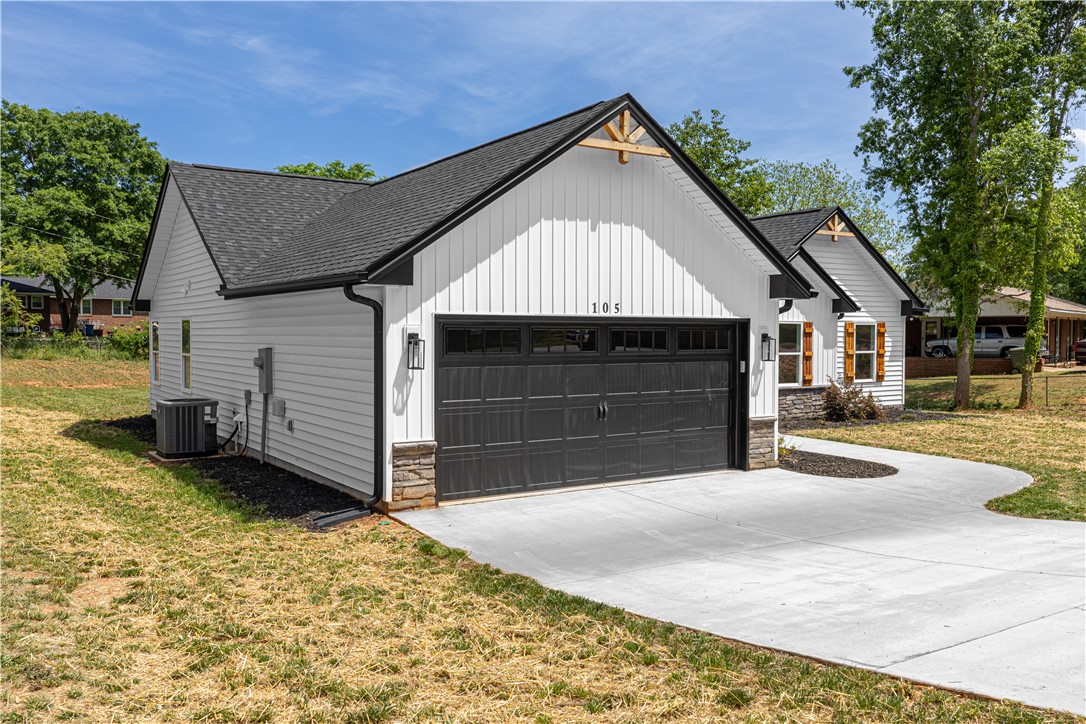 105 Leon Drive Anderson, SC 29621 - Photo 3 of 46 This newly constructed residence offers a sleek facade with an inviting driveway leading to a spacious garage.