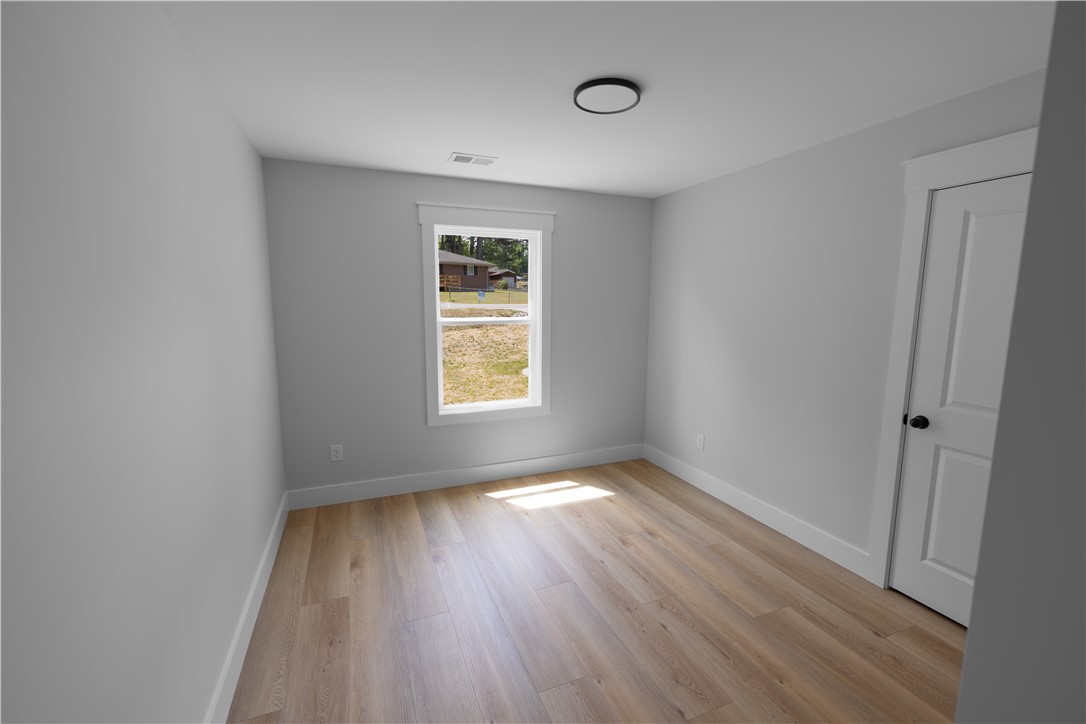 105 Leon Drive Anderson, SC 29621 - Photo 37 of 46 This airy room offers light wood flooring, a window, and a door.