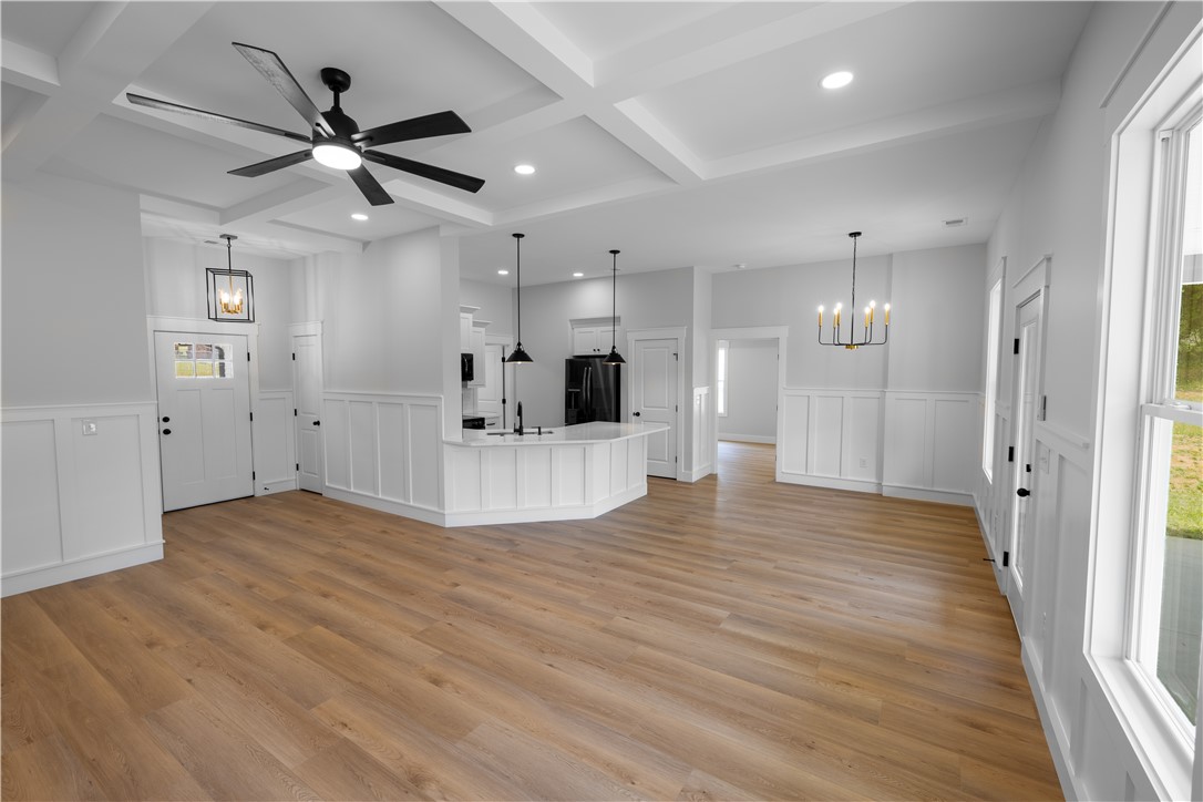105 Leon Drive Anderson, SC 29621 - Photo 38 of 46 Bright and open-concept living area with a well-appointed kitchen and elegant lighting.