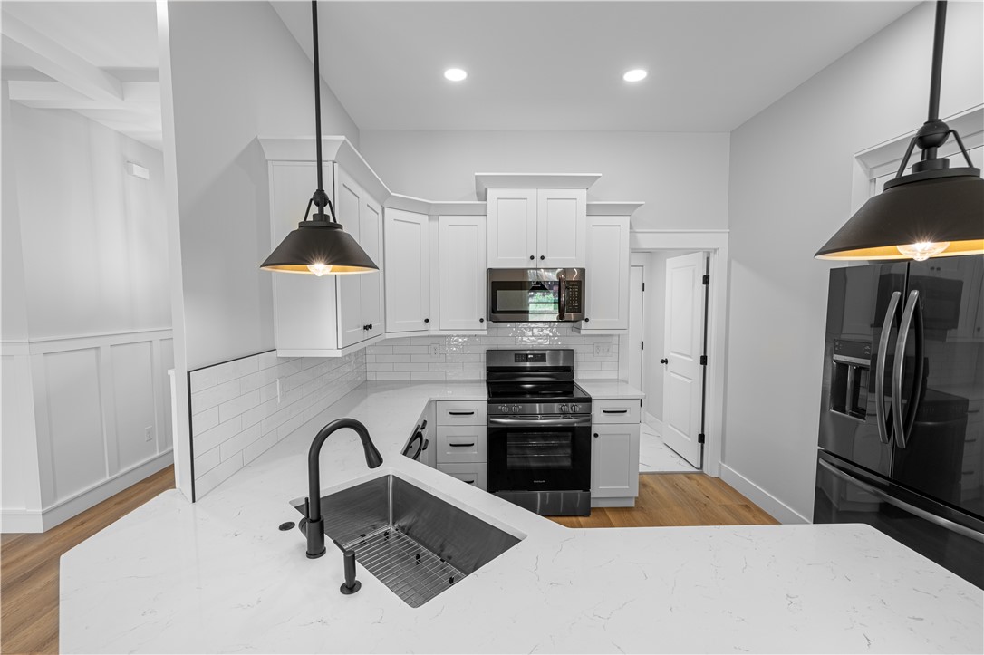 105 Leon Drive Anderson, SC 29621 - Photo 9 of 46 This bright kitchen features white cabinetry and modern appliances, perfect for everyday living.