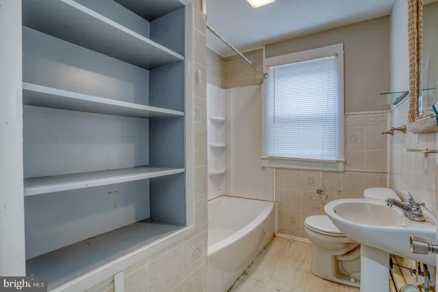 a bathroom with a sink toilet and bathtub