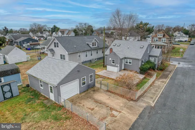 an aerial view of a house with table and chairs