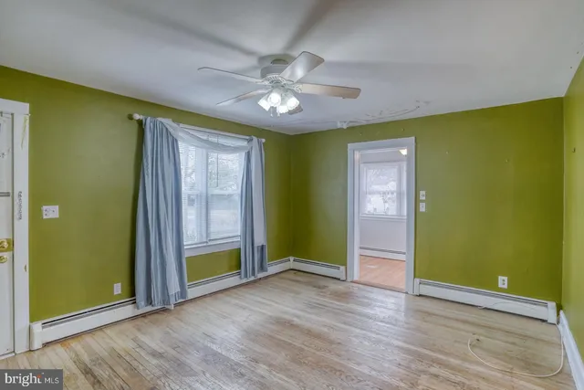 wooden floor in an empty room with a window