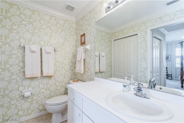 a bathroom with a sink toilet and mirror