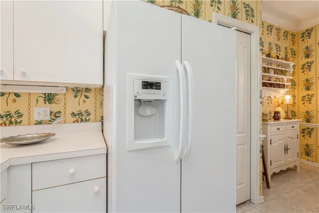a white refrigerator freezer and a window