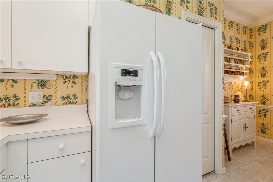 14051 Brant Point Circle, Unit 8105 Fort Myers, FL 33919 - Photo 6 of 33 a white refrigerator freezer and a window