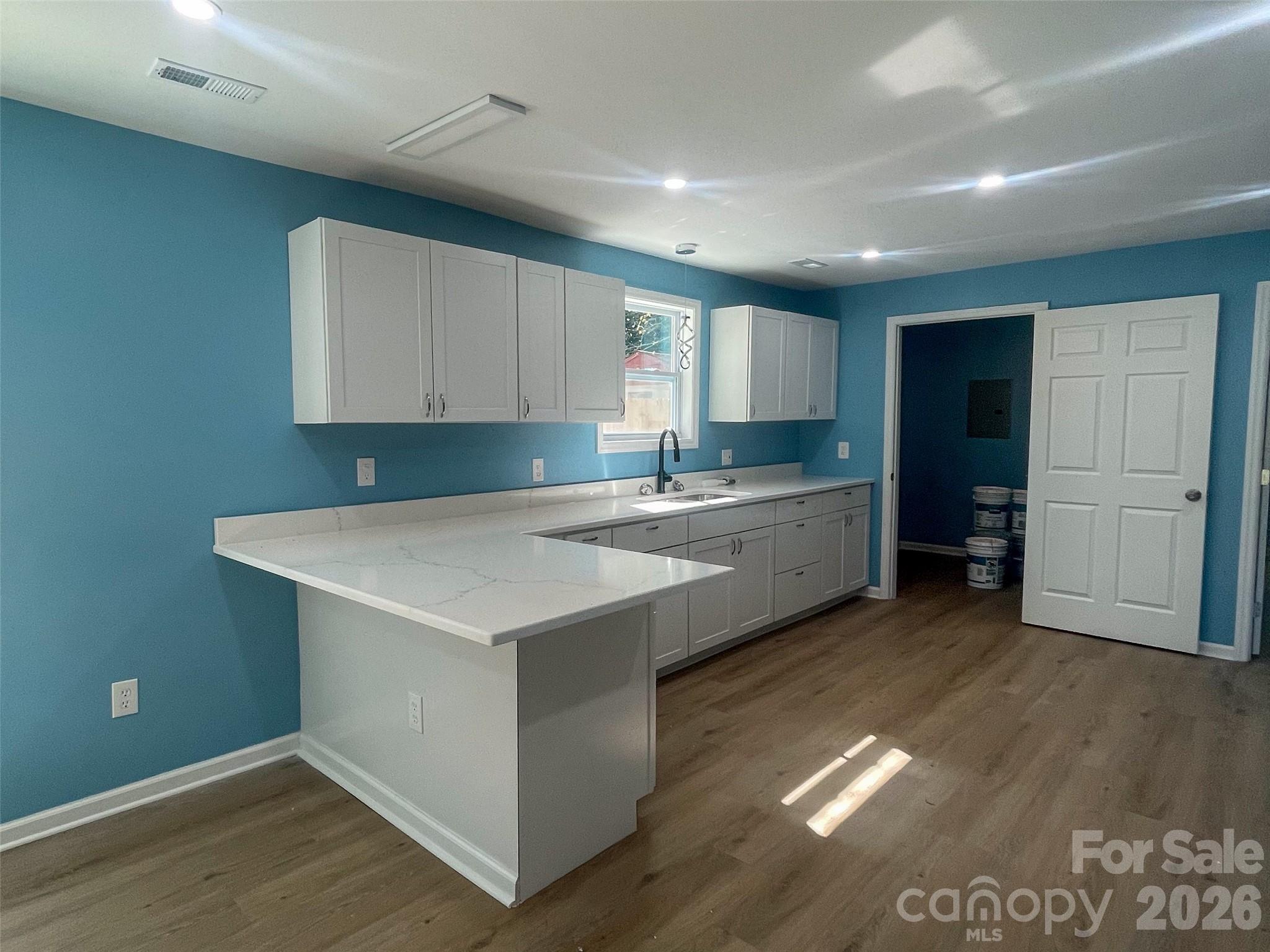 433 Clinton Avenue Lancaster, SC 29720 - Photo 11 of 28 a kitchen with a sink cabinets and wooden floor