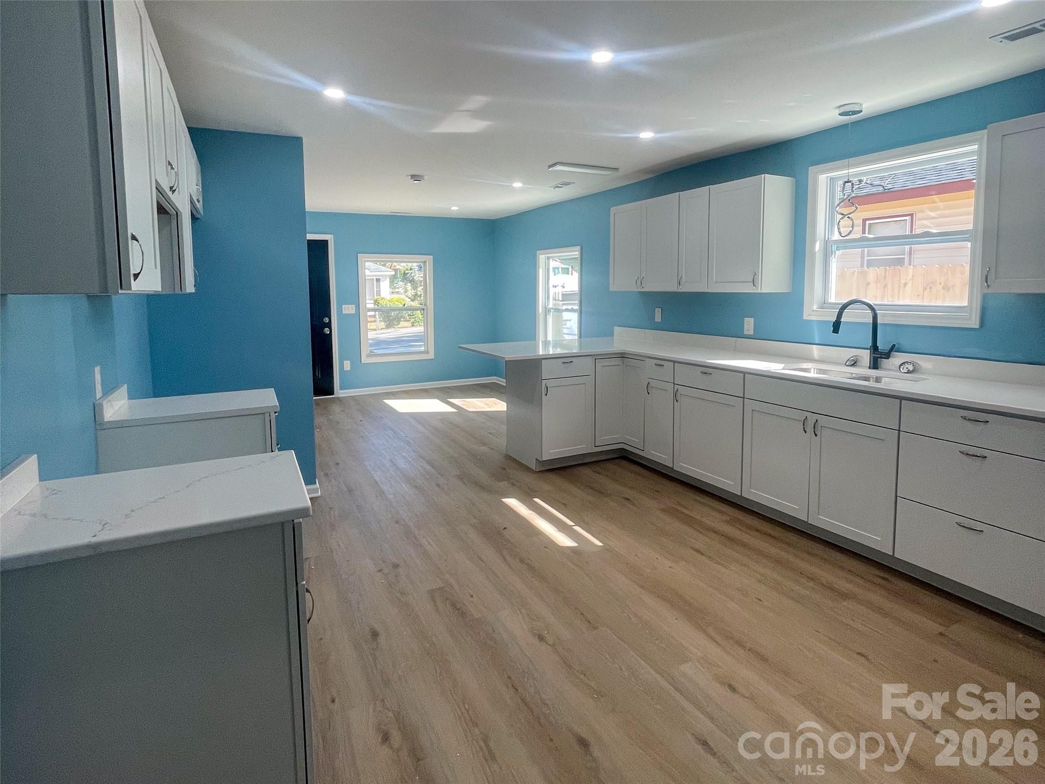 433 Clinton Avenue Lancaster, SC 29720 - Photo 12 of 28 a large kitchen with lot of cabinets and wooden floor