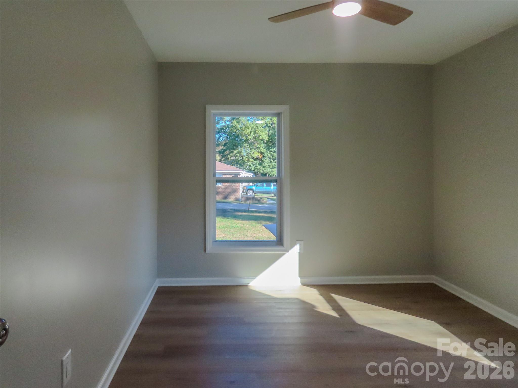 433 Clinton Avenue Lancaster, SC 29720 - Photo 17 of 28 an empty room with wooden floor and windows