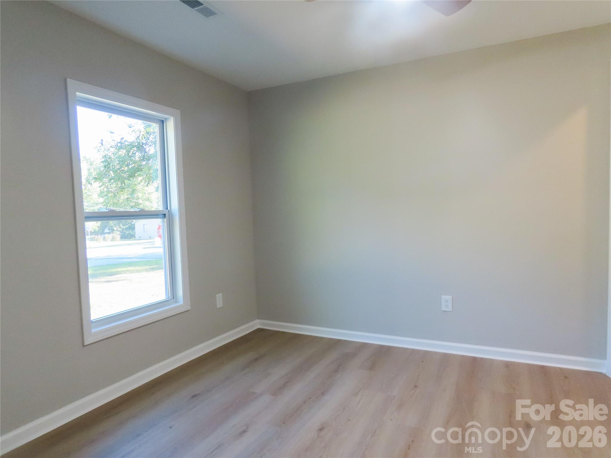 433 Clinton Avenue Lancaster, SC 29720 - Photo 20 of 28 wooden floor in an empty room with a window