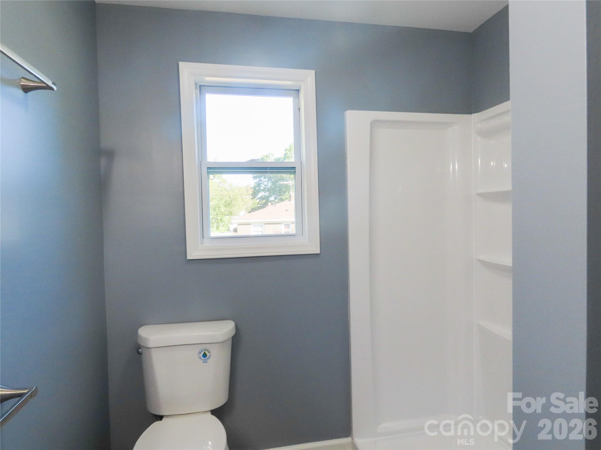 433 Clinton Avenue Lancaster, SC 29720 - Photo 23 of 28 a white toilet sitting next to a bathroom sink