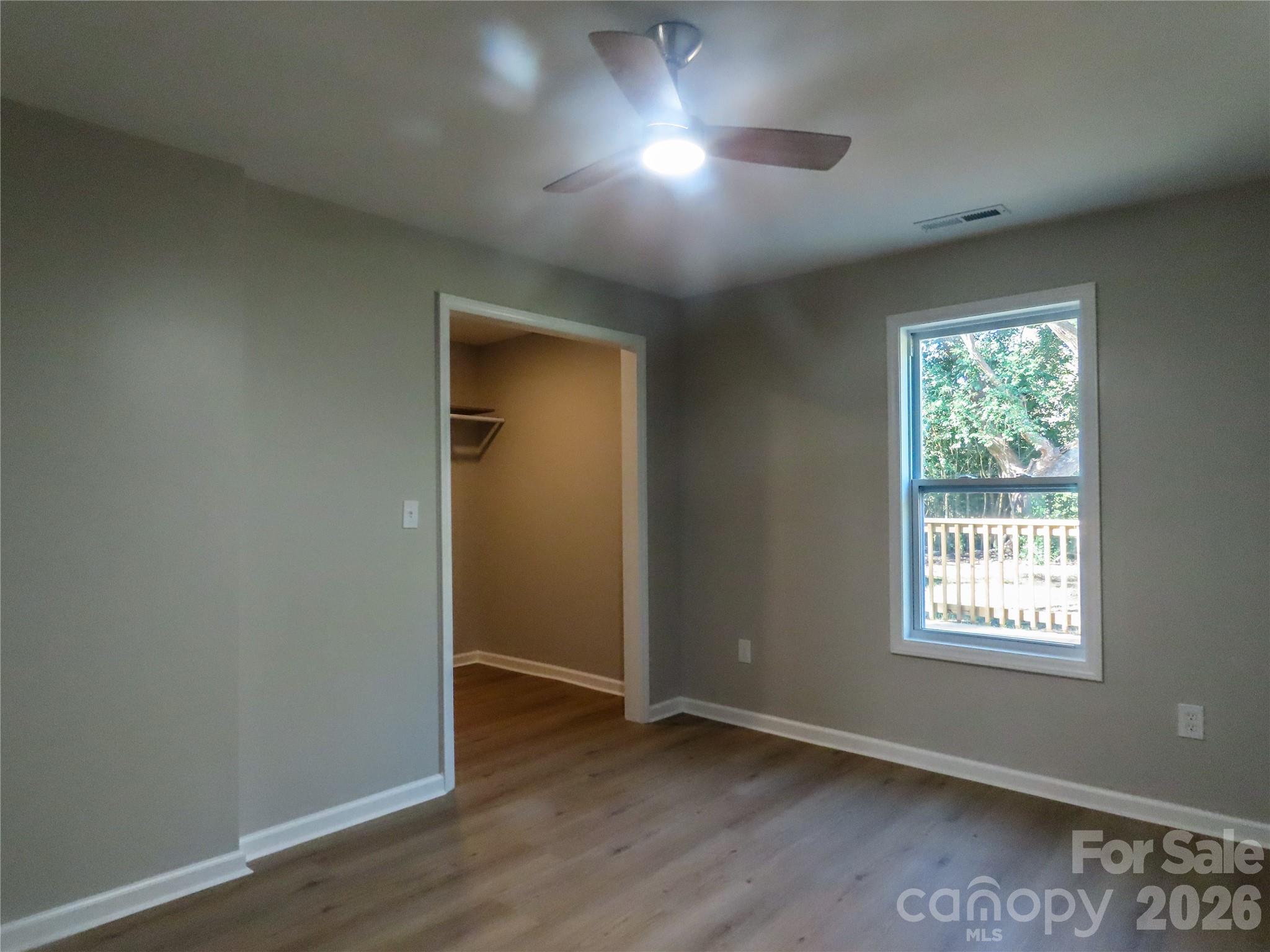 433 Clinton Avenue Lancaster, SC 29720 - Photo 26 of 28 an empty room with wooden floor and windows