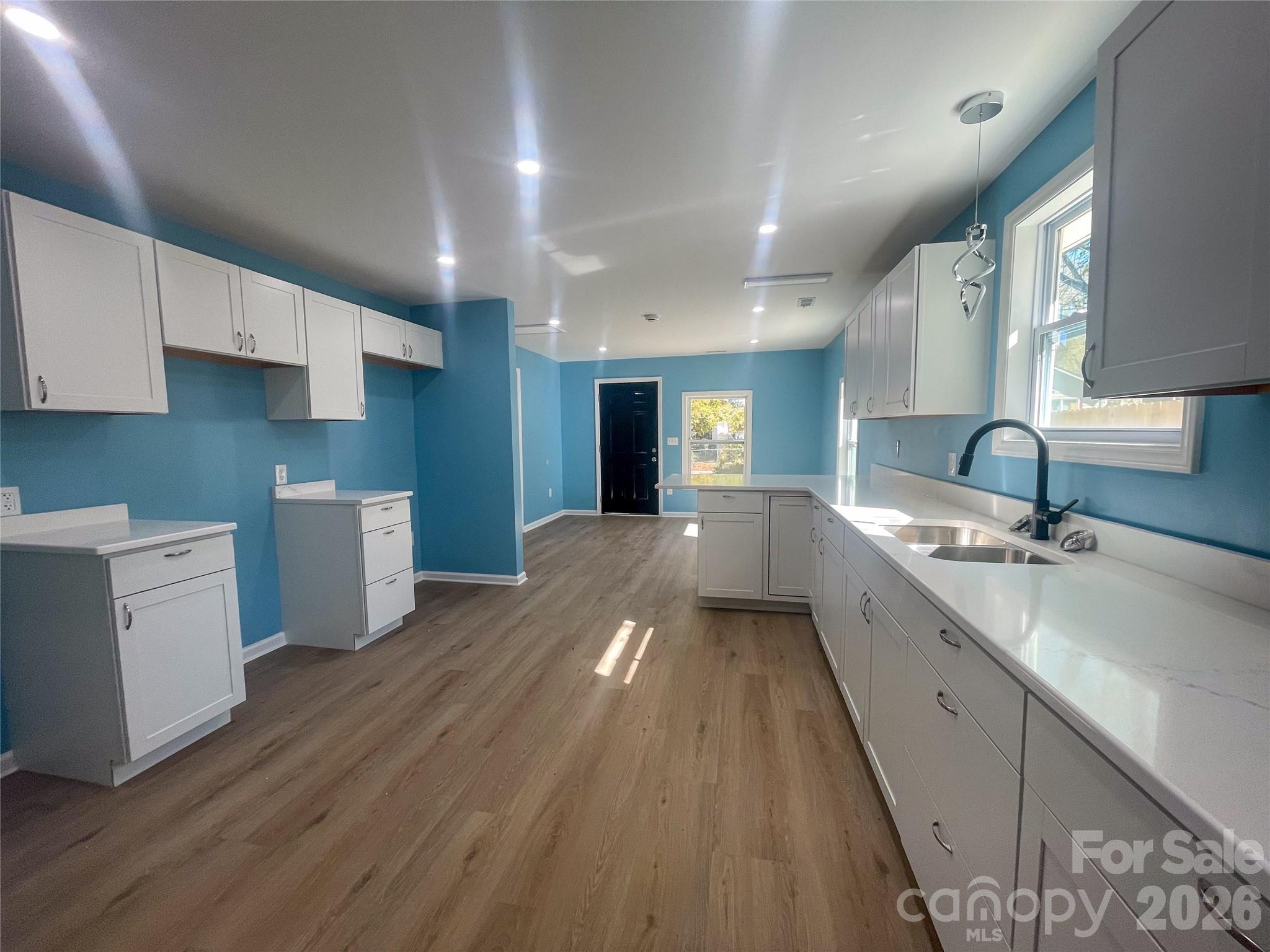 433 Clinton Avenue Lancaster, SC 29720 - Photo 7 of 28 a large kitchen with a lot of counter space and wooden floor