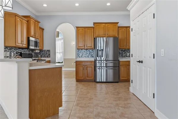 a kitchen with a sink window and cabinets