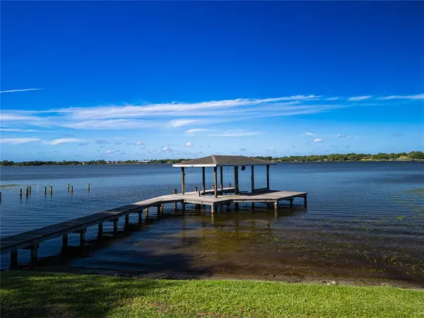 a view of a lake with tables and chairs