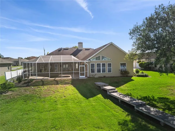 a front view of a house with yard and green space