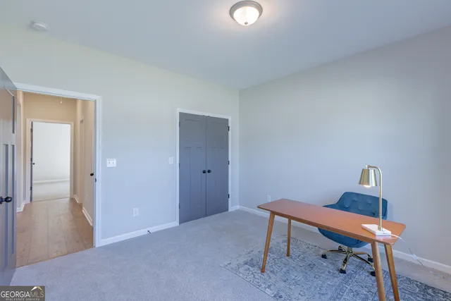 a workspace room with furniture and wooden floor