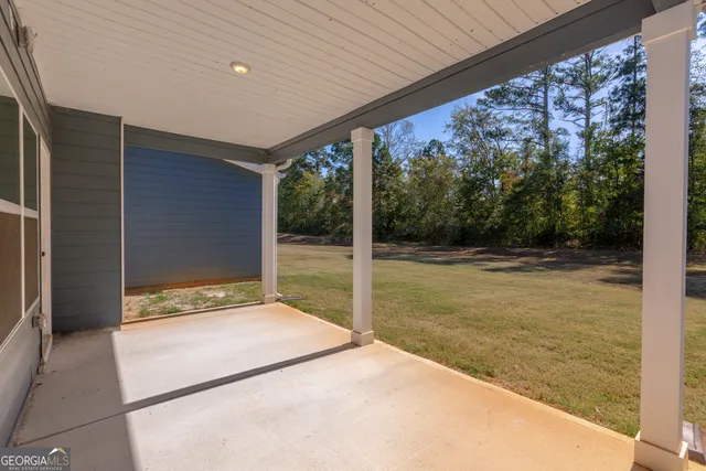 a view of backyard with large trees