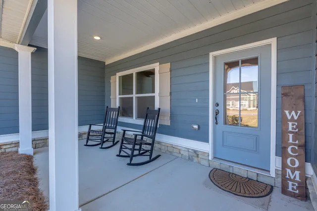 a dining room with furniture and a window