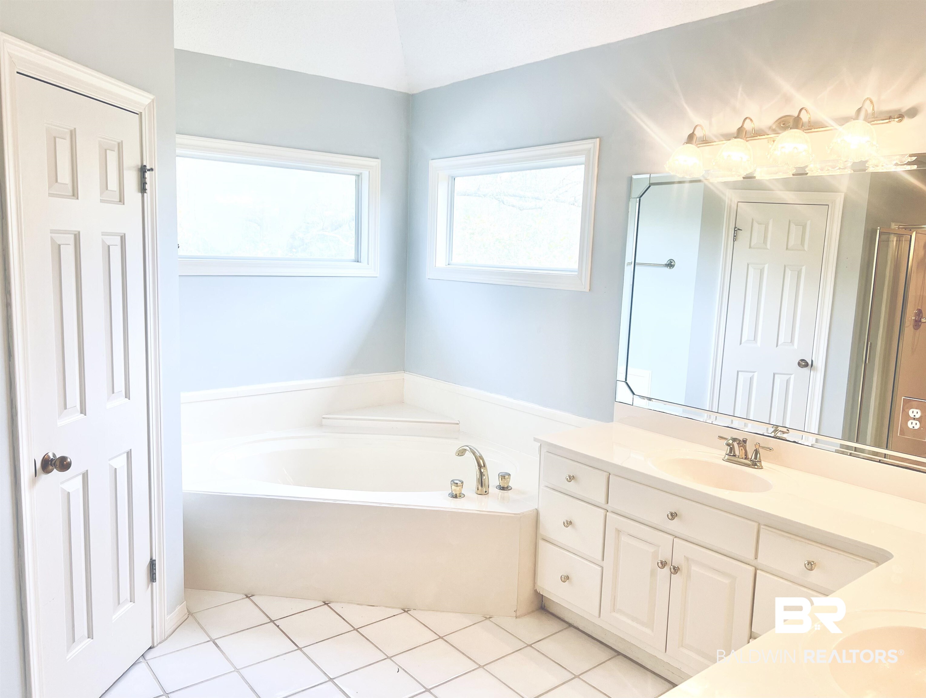 2100 Stonebrook Drive West Mobile, AL 36695 - Photo 32 of 60 Bathroom with vaulted ceiling, tile patterned flooring, vanity, and a garden tub