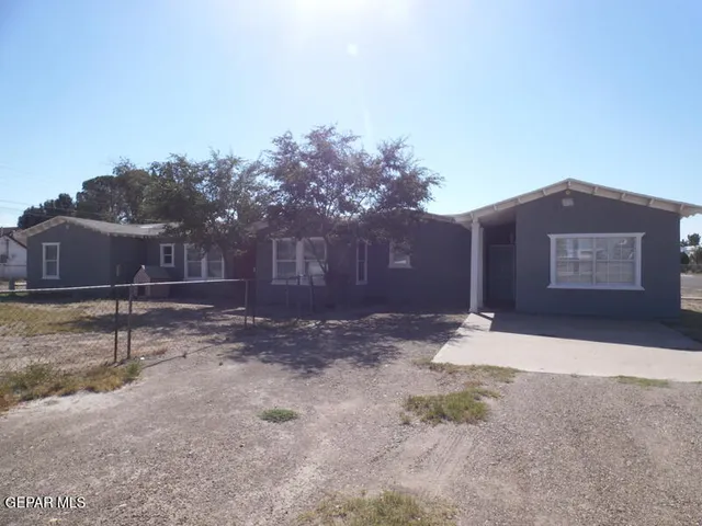 a front view of a house with a yard and a garage