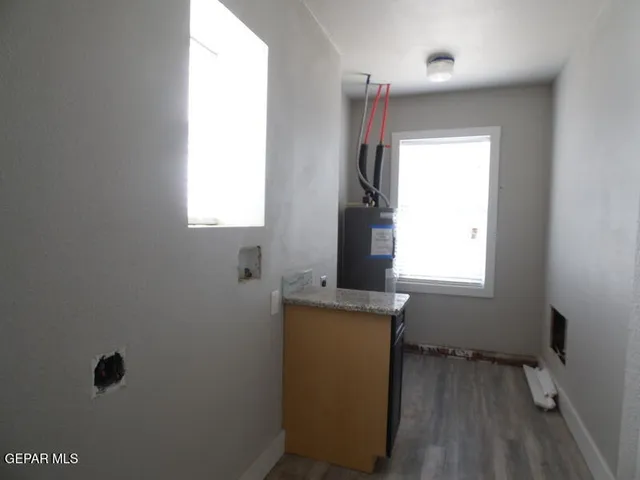 a room with a window and a dresser