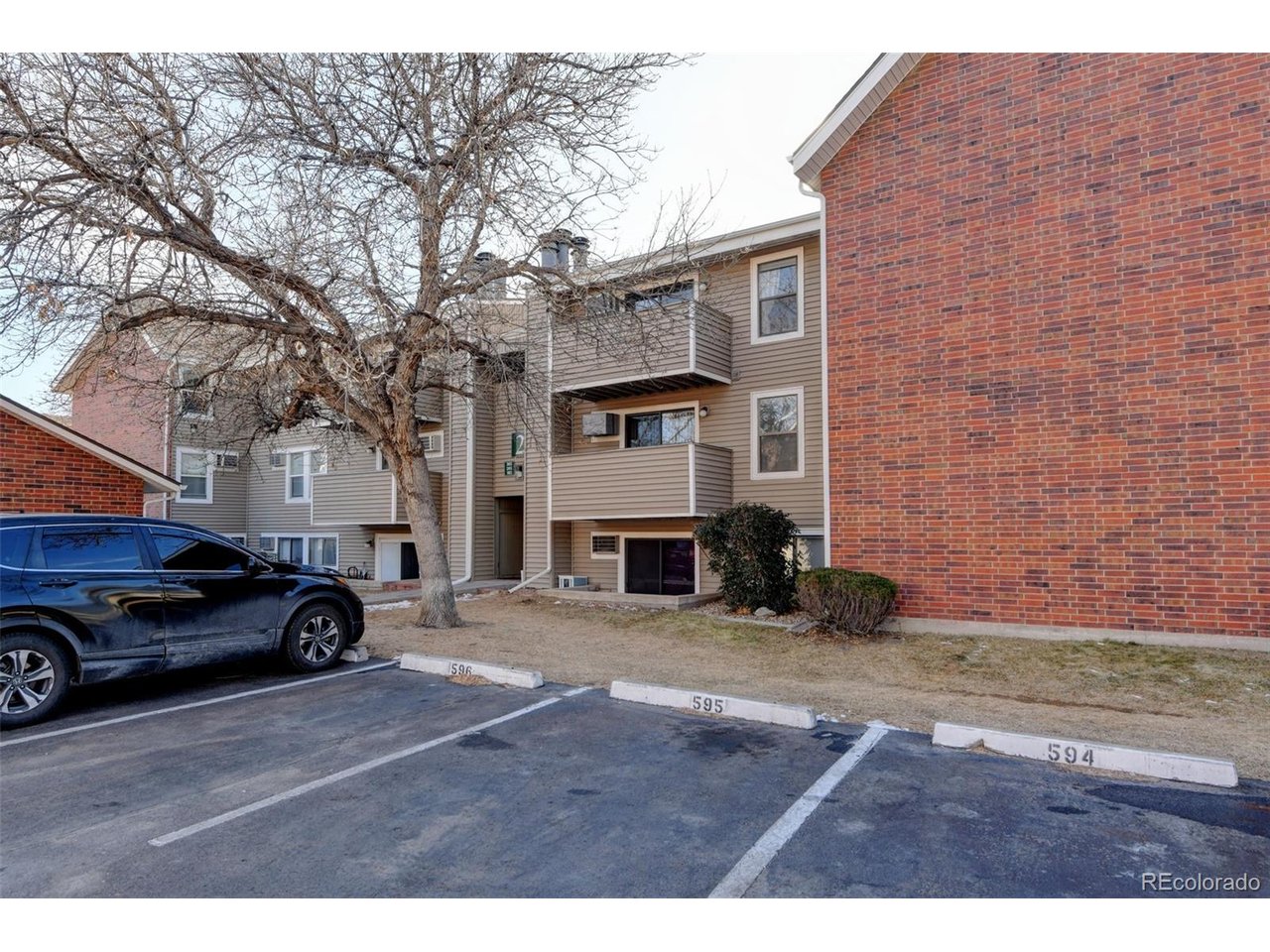 10150 East Virginia Avenue, Unit 2 Denver, CO 80247 - Photo 18 of 20 a view of a car in front of a building