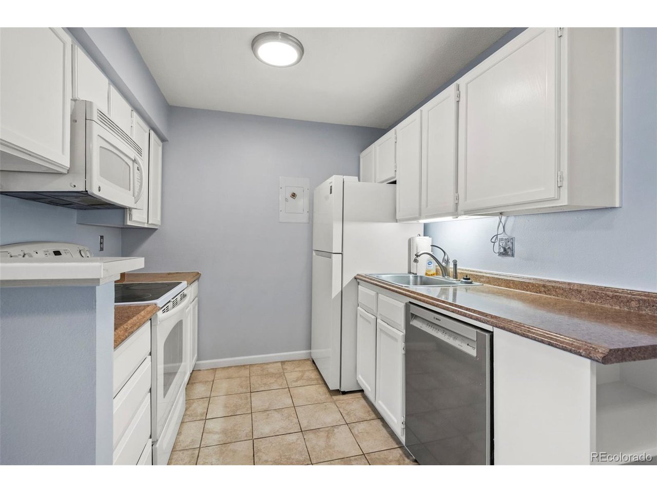 10150 East Virginia Avenue, Unit 2 Denver, CO 80247 - Photo 7 of 20 a kitchen with a sink a stove and refrigerator