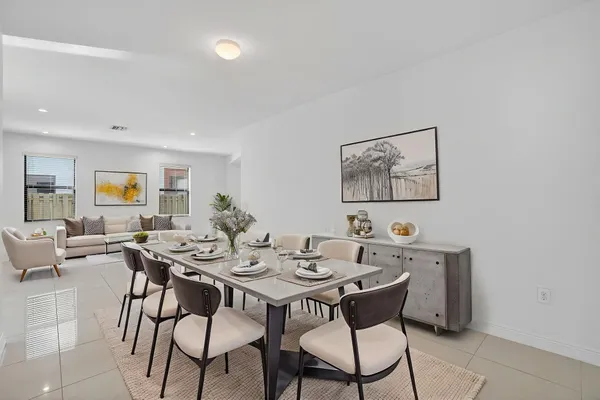 a kitchen with stainless steel appliances a sink a stove a refrigerator and cabinets