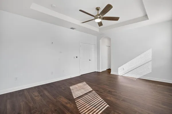 a bathroom with a sink vanity granite tub and a glass door shower