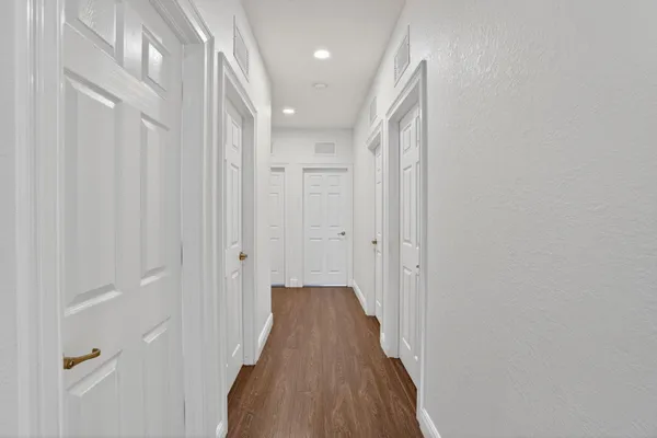 a view of a room with wooden floor and windows
