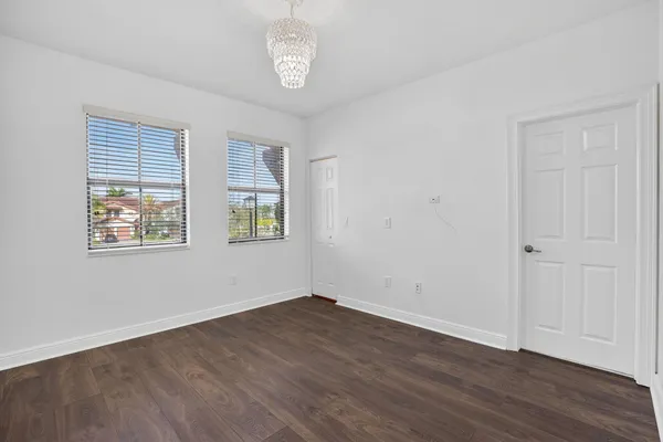 a view of a room with wooden floor