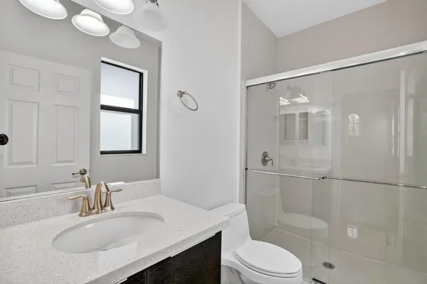 an aerial view of a house with a garden and lake view