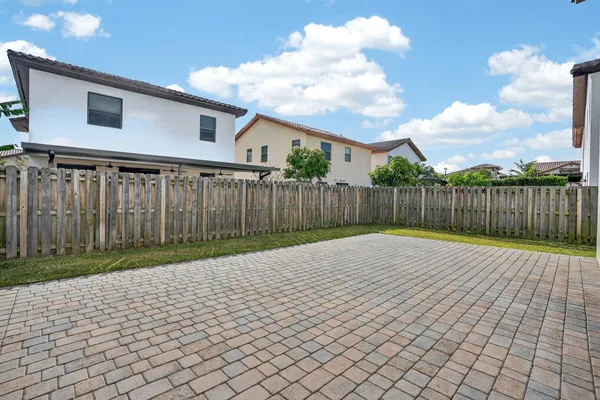 an aerial view of a house with a yard and lake view