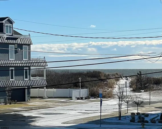 a view of a livingroom with wooden floor and stairs
