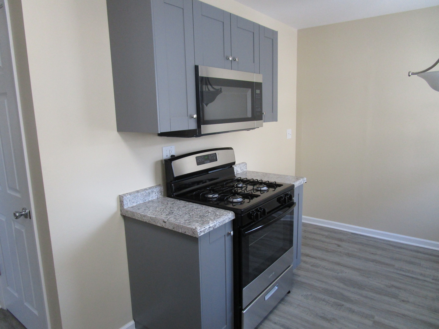 306 Grant Street Harvard, IL 60033 - Photo 5 of 14 a kitchen with granite countertop cabinets and steel stove top oven