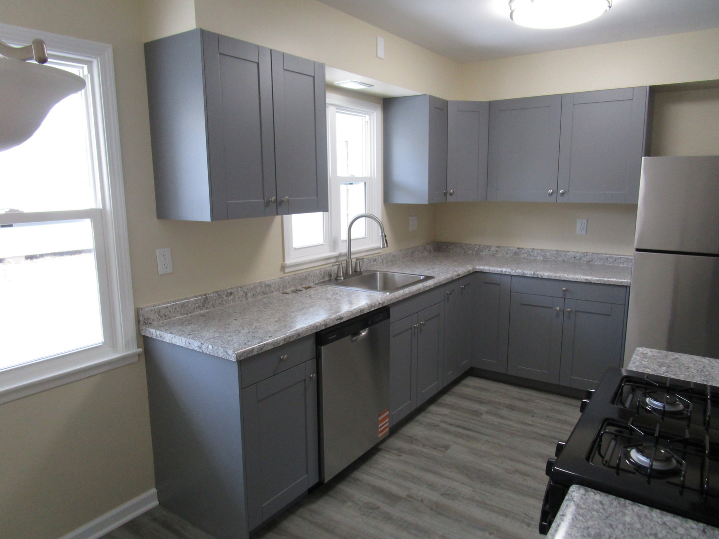 306 Grant Street Harvard, IL 60033 - Photo 6 of 14 a kitchen with a sink stove and cabinets