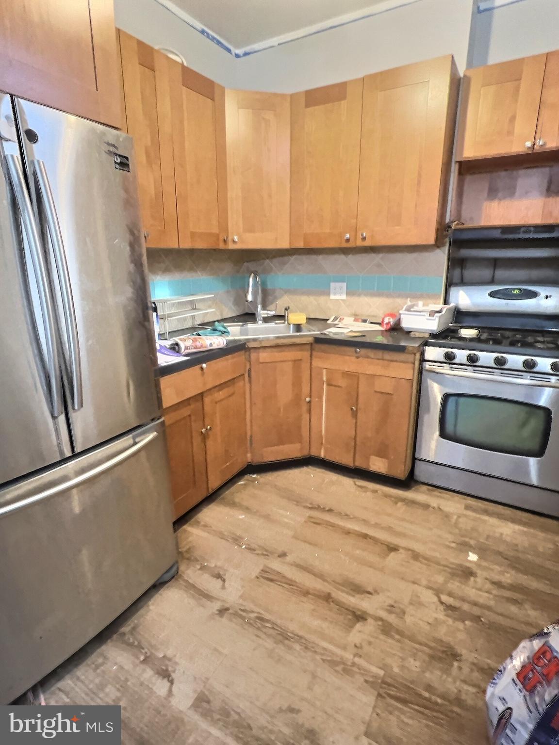 732 North 9th Street Reading, PA 19604 - Photo 7 of 7 a kitchen with granite countertop a refrigerator stove and microwave